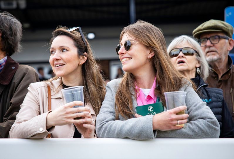 Racegoers enjoying the day beside the rails